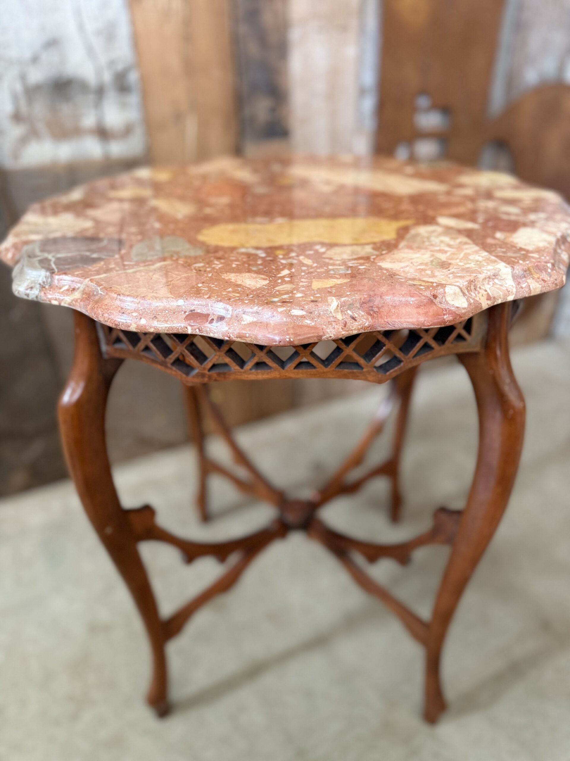 Antique French Louis XV Revival occasional table circa 1900 with a colourful red polychrome breccia marble top, pierced wooden fretwork apron and cabriole legs.
